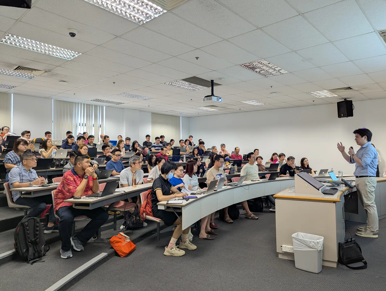 Participants collaborating during an Overpowered AI workshop at Singapore Institute of Management